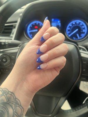 Acrylic almond shaped nail with blue French tip