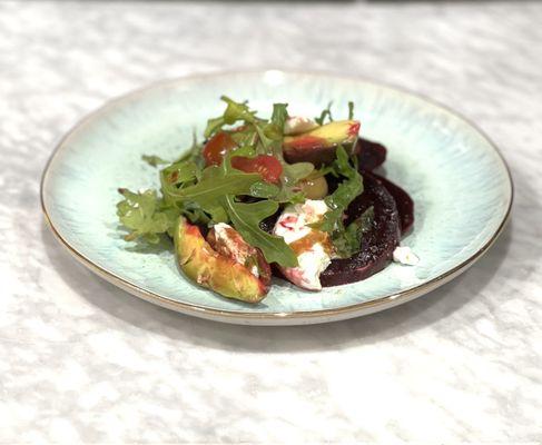 Beet salad with goat cheese, avocado, tomato, arugula, and balsamic glaze. Don't miss this!