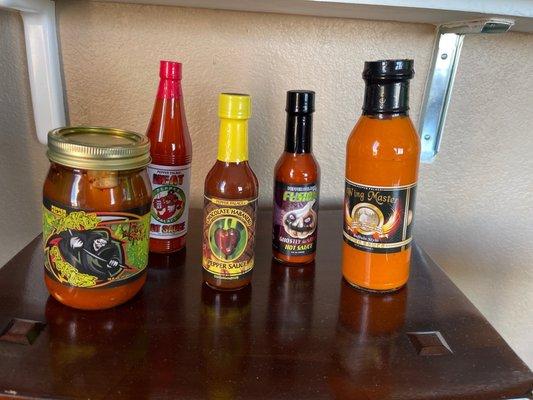 Fear spear pickles, ghost garlic hot sauce, Buffalo sauce, chocolate habanero pepper sauce and pepper palace heat sauce.