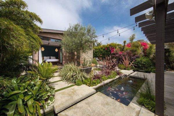 Exposed aggregate concrete stepstones and zen koi pond.