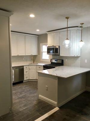 Raised Panel Latte kitchen cabinets with Carrara White marble