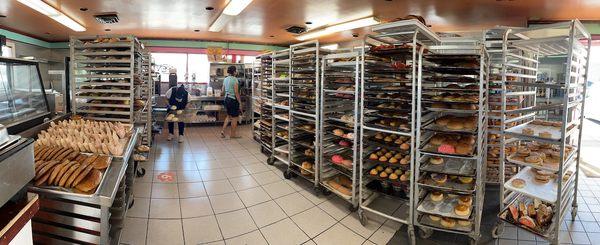 Overwhelming selection of fresh breads and pastries still on the baking racks.