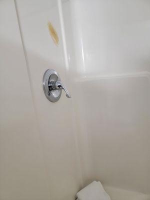 Shower stains and a towel in the shower