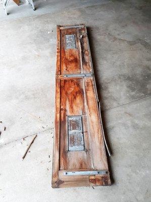 rotted wood panel of garage door removed