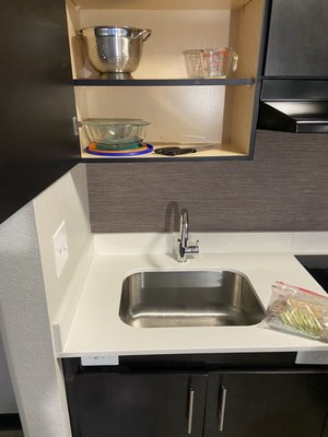 The switch on the bottom right is for the garbage disposal. The knives are on the bottom shelf of a cabinet.