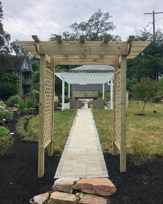 Pergola build and installation alone with mulching the plant beds.