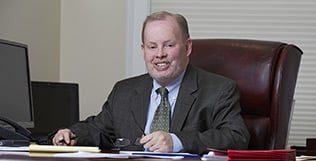 Michael J. Walsh is a founder and principal of the Walsh Woodard LLC law firm.