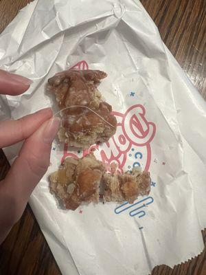 A piece of plastic baked into the donut