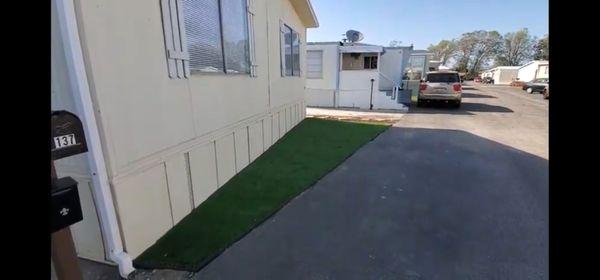 Artificial turf installed near mobile home