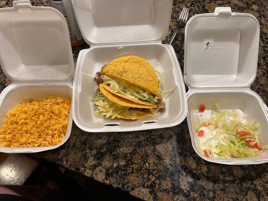 Three hard tacos and rice with pico.