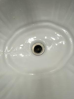 Bathroom sink with no drain cover.