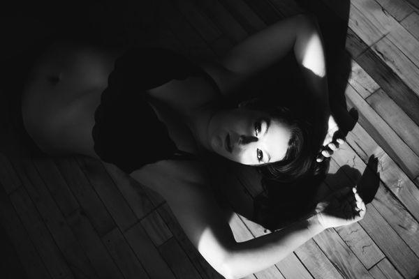 Black and white sexy boudoir photo woman in shadows