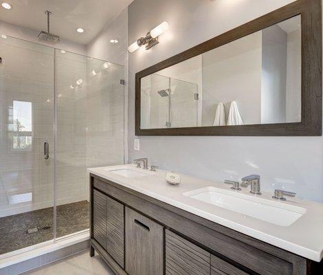 The owners love the warm grey of this master bath as well as the contrast of the pebble floor in the shower.