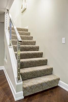 Staircase features 100% New Zealand Wool patterned carpet by Nourison with a waterfall stair installation