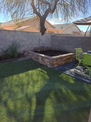 A small garden we installed with stone vaneer and large stone wall caps the garden also soundless as a seat wall for extra guests