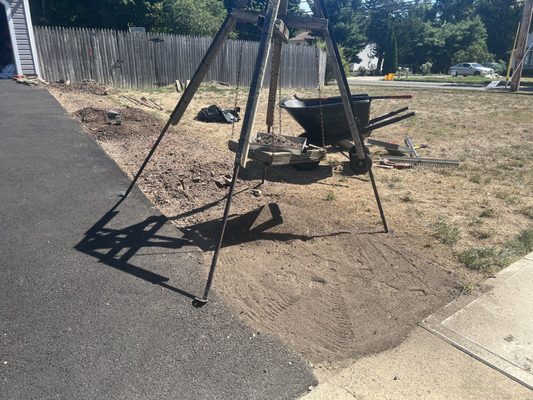 Closer view of the fine mesh sifter being used to screen out the stones from the dirt