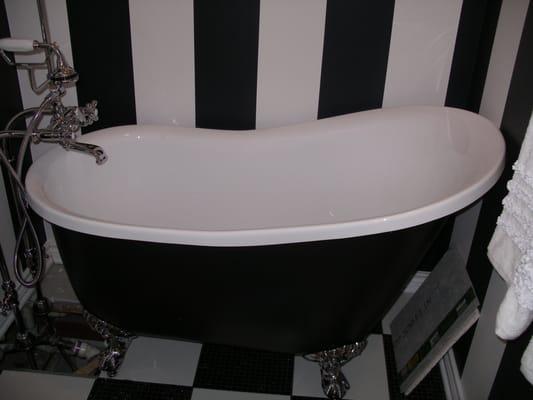 Footed tub with hand painted striped walls and tiled checkerboard floor