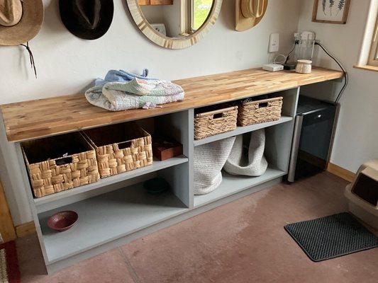 Laundry room shelving with room for a wine fridge.