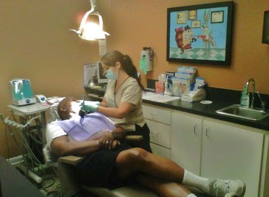 Our hygienist, Jackie, performing a cleaning on a valued patient.