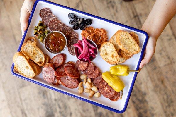 Charcuterie Plate: Assorted Meats from Gagliano's and Cheeses from Springside, featuring Farm Fresh Pickles and Jams.