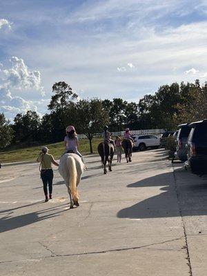 A group headed on a trail ride before their lesson.