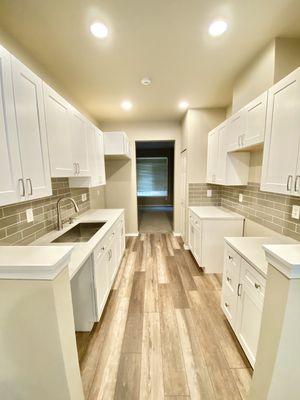 Quartz countertop, white shaker cabinets, subway tile backsplash