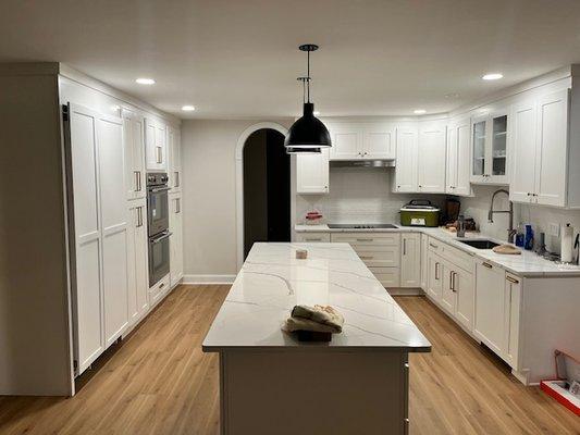 New laminate flooring throughout kitchen, moved walls to create a more spacious area and new cabinets to top it off.