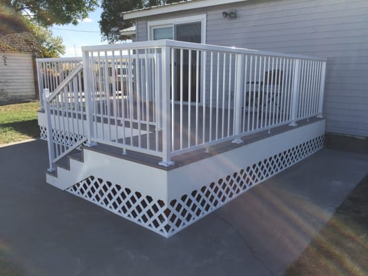 A new deck with composite Azek decking and white aluminum picket railing.