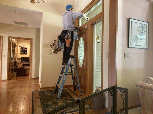 Jim cleaning glass at a clients home.