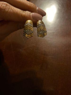 Pair of earrings. The one on the left is the real one.