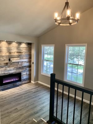 Accent wall with fireplace installation. Everything in this room we replaced to make brand new. Flooring, lighting, paint, etc.