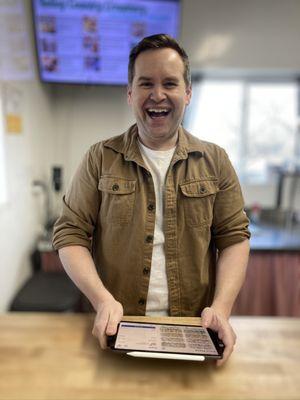 This super friendly bastard takes your order, bags your goods, takes your cash and throws in a couple of treats each time.  Respect!