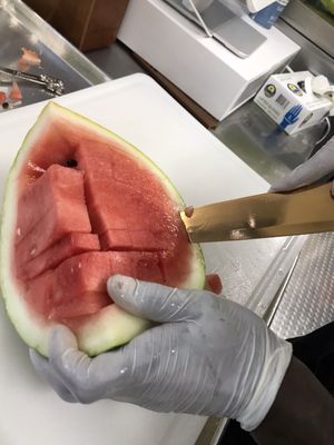 Fresh Watermelon being sliced to be blended and strained!