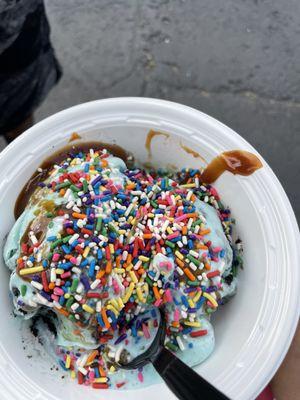 Cookie Monster with rainbow sprinkles and caramel sauce