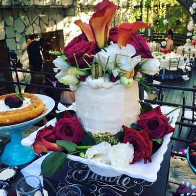 Rustic Wedding Cakes Lemon Raspberry Chiffon Cake with lemon buttercream and a flower headdress.