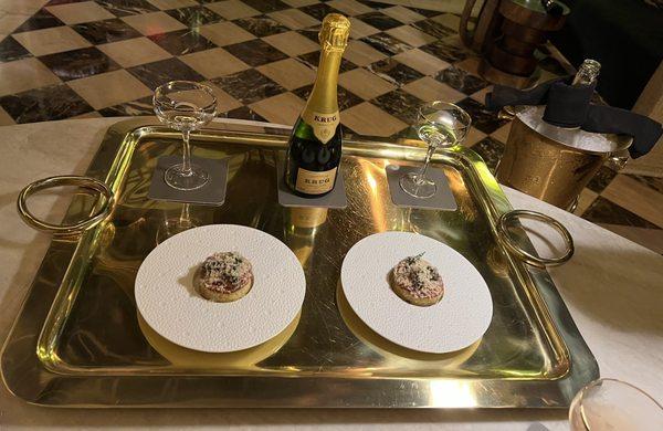 A glass of Krug with small plate pairing