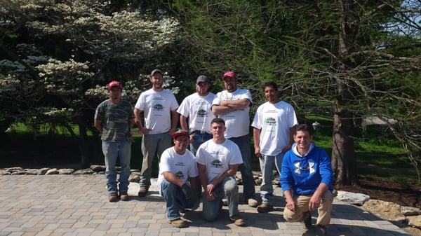 The guys finishing up a paver driveway project. The customer liked the work so much they added doing sidewalk creekstone work...