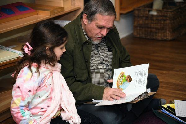 Lower Elementary (6-9) student reading with a teacher