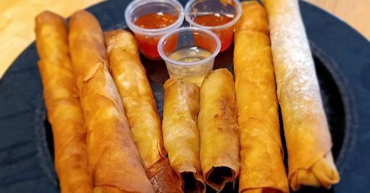 Kimchi ramen lumpia, traditional Shanghai lumpia and pork pancit lumpia with sweet chili and garlic vinegar sauce