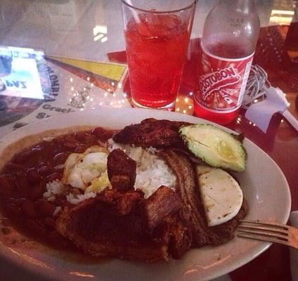 Bandeja Paisa which included: rice, beans, steak, avocado, chicharron, sweet plaintains, eggs and small corncake