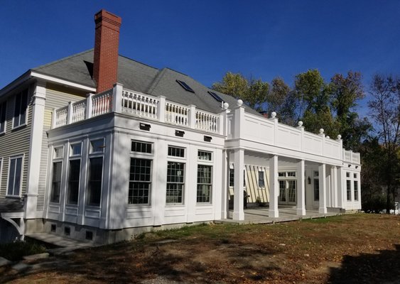 Sunrooms and a terrace added to a Georgian house that open to an expansive rear yard.