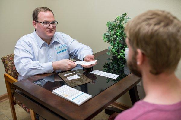 Pharmacist, Tyler, counseling a patient on a compounded medication.