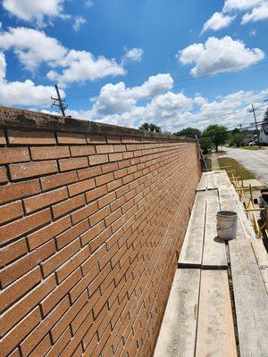 Rebuild of masonry wall, block support wall on the inside as well as the brick face.