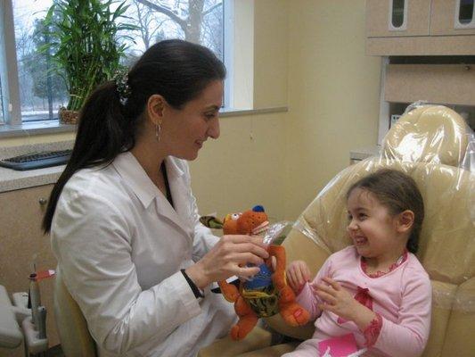 Dr. Nazila Ganji with her young, cute & happy dental patient.