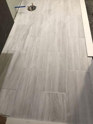 Tile uneven grout lined varying height and depth