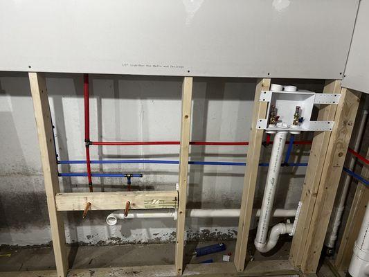 Relocated water and drain lines for wash room