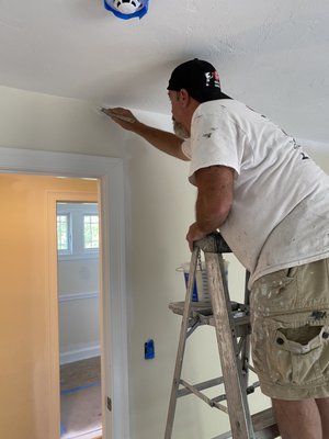 Painting an interior in The Pinehills, Plymouth.