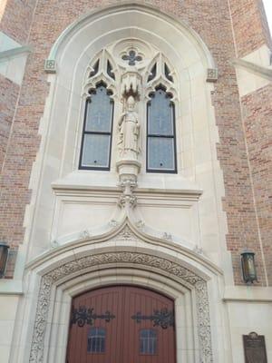 Statue of St. Francis de Sales positioned over the main doors over looking all who enter the Cathedral