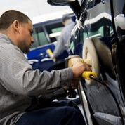 Technician buffing a vehicle