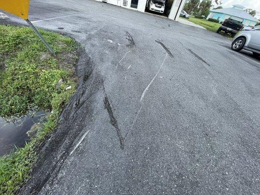 Where hole was 'repaired' ha! Notice sign is bent from cars sliding in. Campbell Automotive.. literally 'cutting corners for profit'!